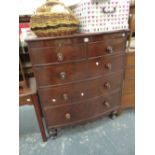 A MID VICTORIAN MAHOGANY BOW FRONT CHEST OF DRAWERS ON TURNED FEET.