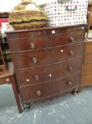 A MID VICTORIAN MAHOGANY BOW FRONT CHEST OF DRAWERS ON TURNED FEET.