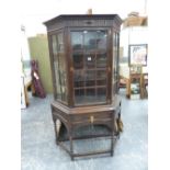 AN OAK DISPLAY CABINET ON BARLEY TWIST STAND.