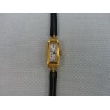 AN 18ct GOLD CASED COCKTAIL WATCH ON A LEATHER STRAP.