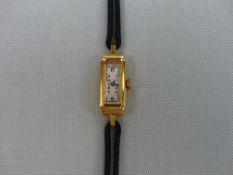 AN 18ct GOLD CASED COCKTAIL WATCH ON A LEATHER STRAP.