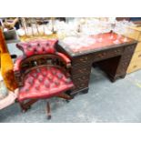 A REPRODUCTION PEDESTAL DESK TOGETHER WITH A SIMILAR BUTTON LEATHER DESK CHAIR.