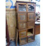 AN OAK SECTIONAL BOOK CASE.