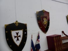 FOUR DECORATIVE WALL SHIELDS.