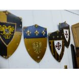 FOUR DECORATIVE WALL SHIELDS.