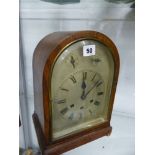 AN OAK CASED THREE TRAIN MANTLE CLOCK.