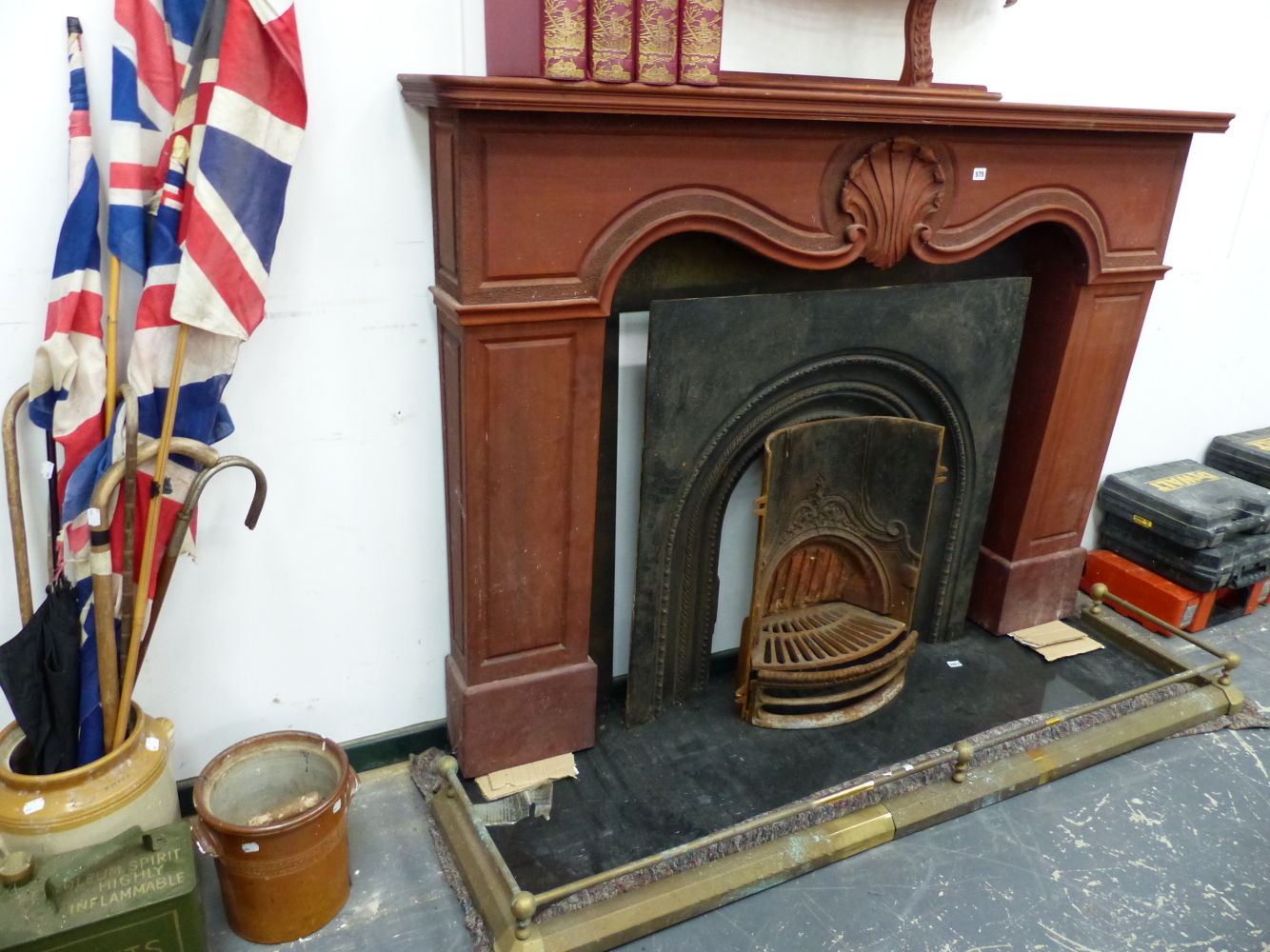 A MAHOGANY FIRE SURROUND AND A CAST IRON FIREPLACE.