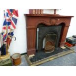 A MAHOGANY FIRE SURROUND AND A CAST IRON FIREPLACE.