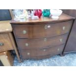 AN ANTIQUE THREE DRAWER BOW FRONT CHEST OF DRAWERS.