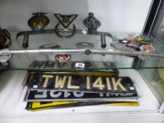 A QUANTITY OF VINTAGE CAR BADGES, NUMBER PLATES ETC.