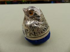 A WHITE METAL MOUNTED BIRD FORM PIN CUSHION.