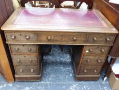 A SMALL VICTORIAN OAK PEDESTAL DESK.