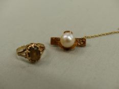 A 9ct GOLD SMOKY QUARTZ RING TOGETHER WITH A YELLOW METAL PEARL SET BROOCH.