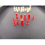 AN ANTIQUE CARVED BONE AND IVORY MINIATURE CHESS BOARD AND PIECES.