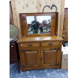 A SMALL ARTS AND CRAFTS STYLE OAK MIRROR BACK SIDEBOARD.