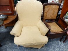 A VICTORIAN STYLE LARGE UPHOLSTERED ARMCHAIR TOGETHER WITH AN EDWARDIAN COMMODE CHAIR.