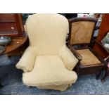 A VICTORIAN STYLE LARGE UPHOLSTERED ARMCHAIR TOGETHER WITH AN EDWARDIAN COMMODE CHAIR.