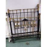 A SET OF PAINTED IRON AND BRASS BED ENDS WITH PORCELAIN DECORATIONS.
