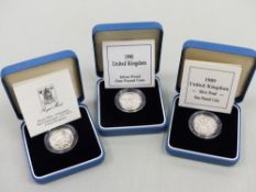 THREE SILVER PROOF COINS.