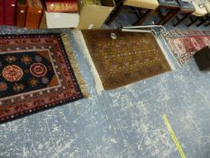 THREE SMALL EASTERN RUGS.