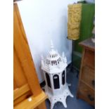 A CAST IRON CONSERVATORY HEATER AND A CANDLE STAND.