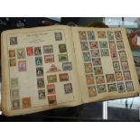 A LARGE STRAND STAMP ALBUM.