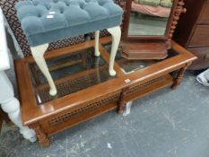 A MODERN GLASS TOP COFFEE TABLE AND A DRESSING STOOL.