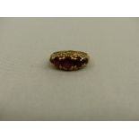 A VINTAGE 9ct GOLD FIVE STONE GARNET RING.