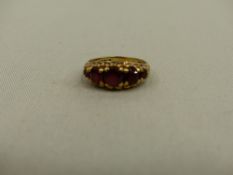 A VINTAGE 9ct GOLD FIVE STONE GARNET RING.