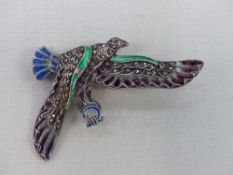 A VINTAGE PLIQUE A JOUR ENAMEL AND MARCASITE SET BIRD IN FLIGHT BROOCH.