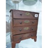 AN ANTIQUE MINIATURE CHEST OF DRAWERS.