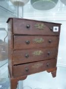 AN ANTIQUE MINIATURE CHEST OF DRAWERS.