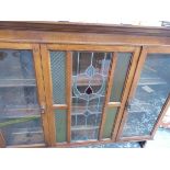 AN ART NOUVEAU GLAZED SIDEBOARD CABINET.