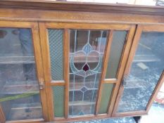 AN ART NOUVEAU GLAZED SIDEBOARD CABINET.