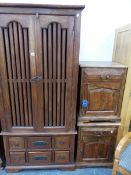 AN EASTERN HARDWOOD WARDROBE AND TWO BEDSIDE CABINETS.