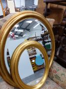 TWO OVAL GILT FRAMED MIRRORS.