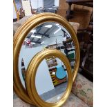 TWO OVAL GILT FRAMED MIRRORS.