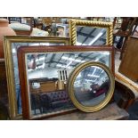 THEE GILT FRAMED WALL MIRRORS AND AN OVAL MANTLE MIRROR.