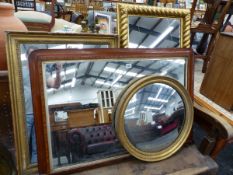 THEE GILT FRAMED WALL MIRRORS AND AN OVAL MANTLE MIRROR.