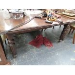 A VICTORIAN MAHOGANY EXTENDING DINING TABLE.
