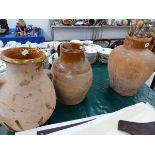 THREE RUSTIC TERRACOTTA JUGS.