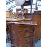 A SMALL SERPENTINE WALNUT CHEST AND A TRIPOD TABLE.