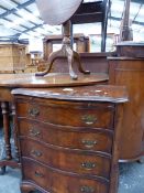 A SMALL SERPENTINE WALNUT CHEST AND A TRIPOD TABLE.