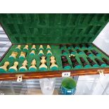 A TURNED WOOD CHESS SET IN FOLDING CHESS BOARD BOX.