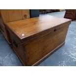 AN ANTIQUE PINE BLANKET BOX.