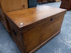 AN ANTIQUE PINE BLANKET BOX.