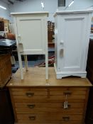 TWO PAINTED BEDSIDE CABINETS, A SMALL ASH CHEST OF DRAWERS, TWO FOLDING TABLES, AND A WICKER HAMPER.