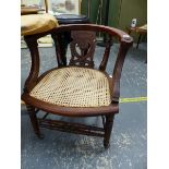 A LATE VICTORIAN DESK CHAIR WITH CANE SEAT.
