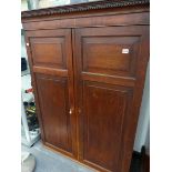 AN 18th C. OAK PANEL DOOR CABINET.