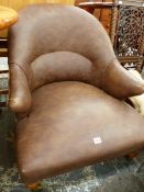 A LEATHER UPHOLSTERD LOW TUB CHAIR.